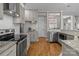 Well-equipped kitchen features stainless appliances, granite countertops, and wood flooring at 5629 Berry Ridge Dr, Harrisburg, NC 28075