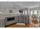 Beautiful kitchen featuring granite countertops, modern lighting, and stainless microwave at 5629 Berry Ridge Dr, Harrisburg, NC 28075