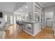 Modern kitchen with granite countertops, pendant lighting, and bar seating, overlooking the living area at 5629 Berry Ridge Dr, Harrisburg, NC 28075