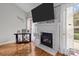 Bright living room with a fireplace, large windows, and hardwood floors at 5629 Berry Ridge Dr, Harrisburg, NC 28075