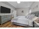 Well lit main bedroom with tray ceiling, hardwood floors, and ensuite bathroom at 5629 Berry Ridge Dr, Harrisburg, NC 28075