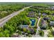 Aerial view of a neighborhood with lush trees and a picturesque pond and fountain at 6024 Glenmore Garden Dr, Charlotte, NC 28270
