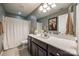 Well-lit bathroom featuring a dark vanity with a white countertop and shower with a white curtain at 6024 Glenmore Garden Dr, Charlotte, NC 28270