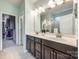 Elegant primary bath features dual sinks, a large mirror, and a separate glass-enclosed shower at 6024 Glenmore Garden Dr, Charlotte, NC 28270