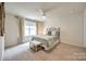 Inviting bedroom featuring neutral walls, carpet, and a window letting in natural light at 6024 Glenmore Garden Dr, Charlotte, NC 28270