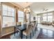 Bright dining area with large windows, a modern chandelier, and a seamless transition to the living room at 6024 Glenmore Garden Dr, Charlotte, NC 28270