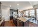 Open concept kitchen with center island featuring granite countertops, ample cabinet space, and stainless steel appliances at 6024 Glenmore Garden Dr, Charlotte, NC 28270