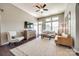 Bright living room with high ceilings, lots of natural light, a ceiling fan, and contemporary furnishings at 6024 Glenmore Garden Dr, Charlotte, NC 28270