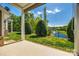 Relaxing covered patio with a scenic backyard view of the pond and lush greenery at 6024 Glenmore Garden Dr, Charlotte, NC 28270