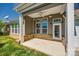 Covered patio featuring a ceiling fan, ample windows, and access to the backyard at 6024 Glenmore Garden Dr, Charlotte, NC 28270