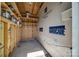 Unfinished storage room with wooden shelves, perfect for organization and storage solutions at 6024 Glenmore Garden Dr, Charlotte, NC 28270