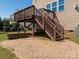Spacious backyard featuring a wooden deck and stairs leading to a stone patio at 6061 Piscataway Ct, Rock Hill, SC 29732