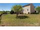 Spacious backyard with a tree and lush green lawn with a fence for privacy at 6061 Piscataway Ct, Rock Hill, SC 29732