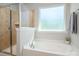 Bright bathroom with a separate tub and shower with neutral paint at 6061 Piscataway Ct, Rock Hill, SC 29732