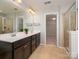 Bright bathroom with double vanity sinks, a walk-in shower, and a walk-in closet at 6061 Piscataway Ct, Rock Hill, SC 29732