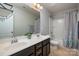 Well-lit bathroom with dual sinks, a large mirror, and a shower-tub combination at 6061 Piscataway Ct, Rock Hill, SC 29732