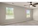 Bedroom with neutral carpeting, neutral colored walls, and two windows at 6061 Piscataway Ct, Rock Hill, SC 29732