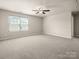 Bonus room featuring a window, neutral colored walls, carpet, and a ceiling fan at 6061 Piscataway Ct, Rock Hill, SC 29732