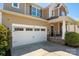 Close-up of a two-car garage with a white door and a well-maintained driveway at 6061 Piscataway Ct, Rock Hill, SC 29732
