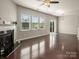 Spacious living room with hardwood floors, a fireplace, and large windows for natural light at 6061 Piscataway Ct, Rock Hill, SC 29732