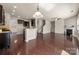 Open-concept living room with dark hardwood floors, a fireplace, and a view of the kitchen and staircase at 6061 Piscataway Ct, Rock Hill, SC 29732
