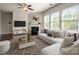 Comfortable living room featuring modern decor, a fireplace, and large windows for natural light at 6061 Piscataway Ct, Rock Hill, SC 29732