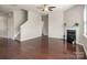 Bright living room with a fireplace, hardwood floors, and a view of the staircase at 6061 Piscataway Ct, Rock Hill, SC 29732