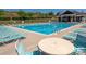 Community pool with plenty of lounge chairs and a covered seating area at 6061 Piscataway Ct, Rock Hill, SC 29732