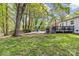 Spacious backyard featuring a patio with an outdoor dining area and a wooden deck at 6127 Rosecrest Dr, Charlotte, NC 28210