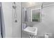 Bathroom featuring shower with white tiling, a vanity with a sink, and a mirror at 6127 Rosecrest Dr, Charlotte, NC 28210