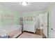 Bright bedroom with ample closet space, neutral color scheme, and a baby's crib at 6127 Rosecrest Dr, Charlotte, NC 28210