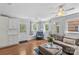Bright living room with updated flooring, ceiling fan, and a large sofa perfect for entertaining at 6127 Rosecrest Dr, Charlotte, NC 28210