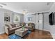 Cozy living room with stylish sliding barn doors, a comfortable couch, and charming decor at 6127 Rosecrest Dr, Charlotte, NC 28210