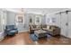 Inviting living room featuring hardwood floors, a comfortable sectional sofa, and plenty of natural light at 6127 Rosecrest Dr, Charlotte, NC 28210