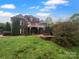 Spacious backyard with a deck and outdoor fireplace at 6204 River Birch Dr, Gastonia, NC 28056