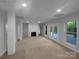 Spacious basement with tile floors, brick pillar and fireplace, with French doors for outdoor access at 6204 River Birch Dr, Gastonia, NC 28056