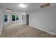 Neutral bedroom provides natural light through multiple windows, fresh paint, and new carpet at 6204 River Birch Dr, Gastonia, NC 28056
