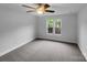 Bedroom with neutral walls, two windows, and a ceiling fan at 6204 River Birch Dr, Gastonia, NC 28056