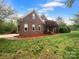 Brick home with a manicured lawn and mature landscaping at 6204 River Birch Dr, Gastonia, NC 28056