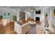 Bright living room with a fireplace, wood floors, and built-in shelving at 6204 River Birch Dr, Gastonia, NC 28056