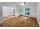 Bright living room with hardwood floors, wainscoting, large windows, and access to a patio at 6204 River Birch Dr, Gastonia, NC 28056