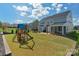 Spacious backyard with a playground, patio, screened porch, and manicured lawn at 8008 Hudson Mill Dr, Waxhaw, NC 28173