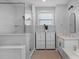 Modern bathroom showcasing a glass-enclosed shower, dual vanities, and stylish storage cabinets at 8008 Hudson Mill Dr, Waxhaw, NC 28173
