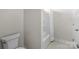 Bright, simple bathroom with a toilet and a shower-tub combo with a white shower curtain at 8008 Hudson Mill Dr, Waxhaw, NC 28173