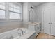 Bright bathroom featuring a tub, window, and a sleek vanity with modern fixtures at 8008 Hudson Mill Dr, Waxhaw, NC 28173