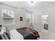Cozy bedroom featuring natural light, neutral walls, and a view into the attached bathroom at 8008 Hudson Mill Dr, Waxhaw, NC 28173
