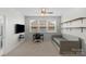 This bedroom with a daybed and wall mounted shelving and large windows offers a great place to relax at 8008 Hudson Mill Dr, Waxhaw, NC 28173