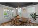 Dining room with a stylish light fixture, large windows, and a wooden table with six chairs, and dark ceiling at 8008 Hudson Mill Dr, Waxhaw, NC 28173