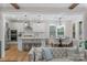 Modern kitchen with white cabinetry, stainless steel appliances, and a large island with bar seating overlooking the living room at 8008 Hudson Mill Dr, Waxhaw, NC 28173