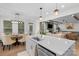 Open kitchen featuring a large island, modern pendant lights, stainless steel appliances, and an adjoining living area at 8008 Hudson Mill Dr, Waxhaw, NC 28173
